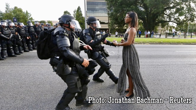 A demonstrator protesting the shooting death of Alton Sterling is detained by law enforcement near the headquarters of the Baton Rouge Police Department in Baton Rouge, Louisiana